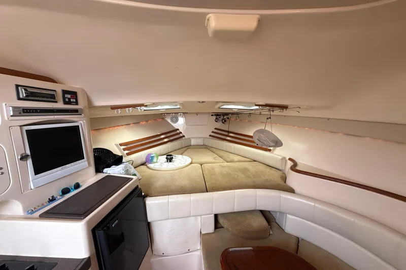 Slide: The Image of 2005 Grady-White Express 330 cabin interior with seating, table, and entertainment system. - 27