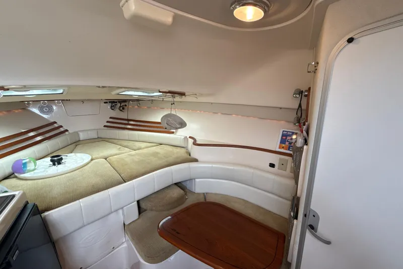 Slide: The Image of 2005 Grady-White Express 330 cabin interior with cozy seating and wooden table. - 29