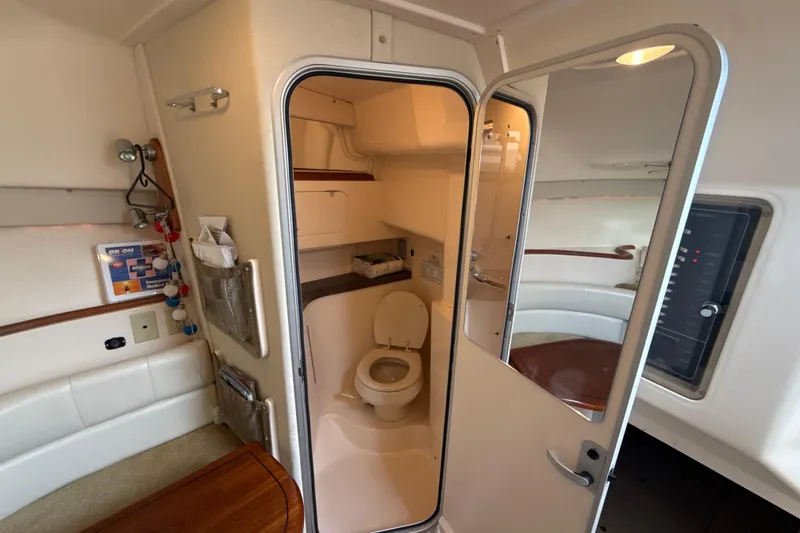 Slide: The Image of Interior of a 2005 Grady-White Express 330 boat featuring a compact bathroom. - 31