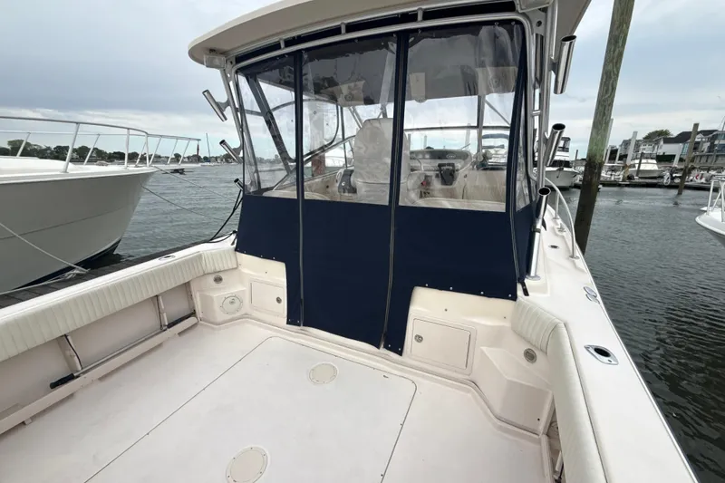 Slide: The Image of 2005 Grady-White Express 330 boat docked, featuring spacious deck and enclosed cockpit. - 33