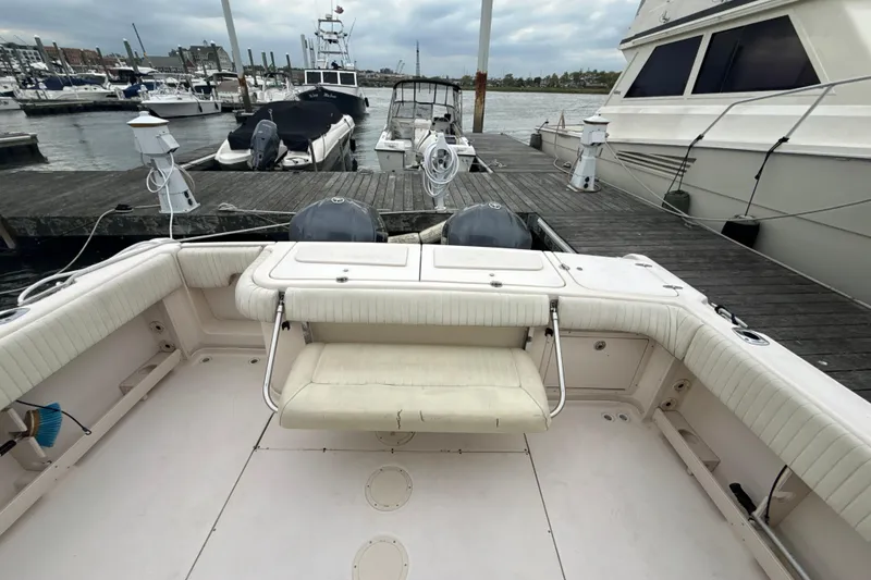 Slide: The Image of 2005 Grady-White Express 330 boat docked at marina, featuring spacious seating and twin engines. - 42