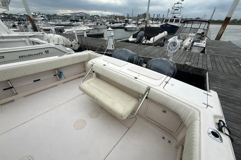 Slide: The Image of 2005 Grady-White Express 330 boat docked at marina with seating and twin engines. - 44