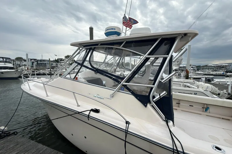 Slide: The Image of 2005 Grady-White Express 330 boat docked at marina under cloudy sky. - 46