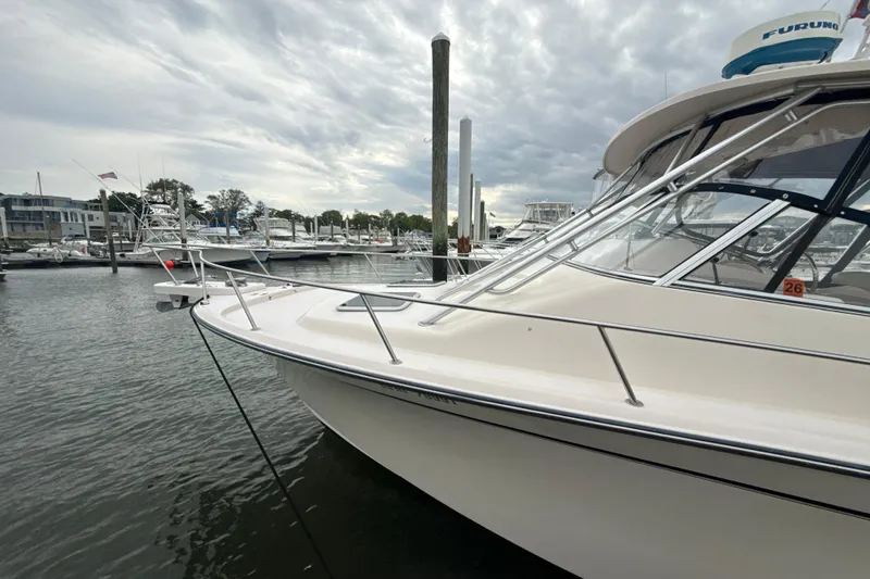 Slide: The Image of 2005 Grady-White Express 330 boat docked at a marina under cloudy skies. - 47