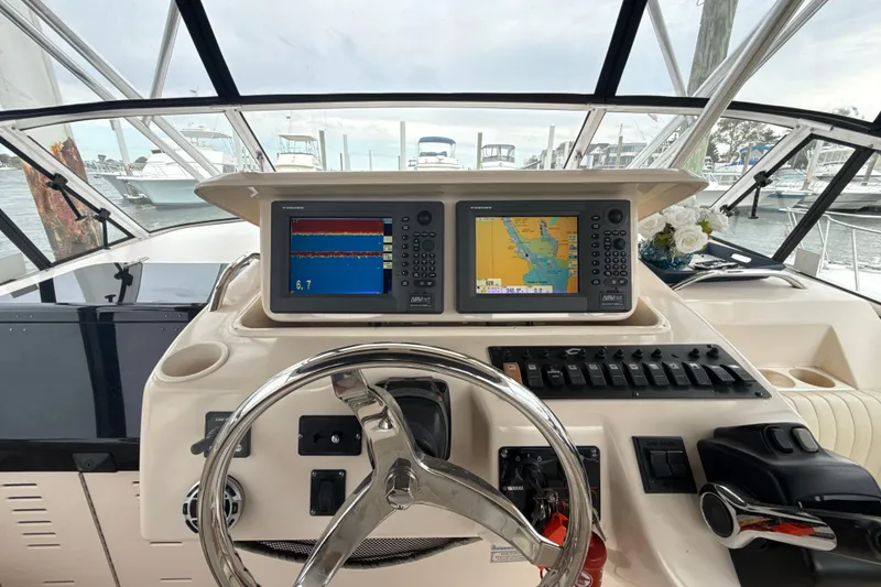 Slide: The Image of Cockpit of 2005 Grady-White Express 330 with navigation screens and steering wheel. - 6