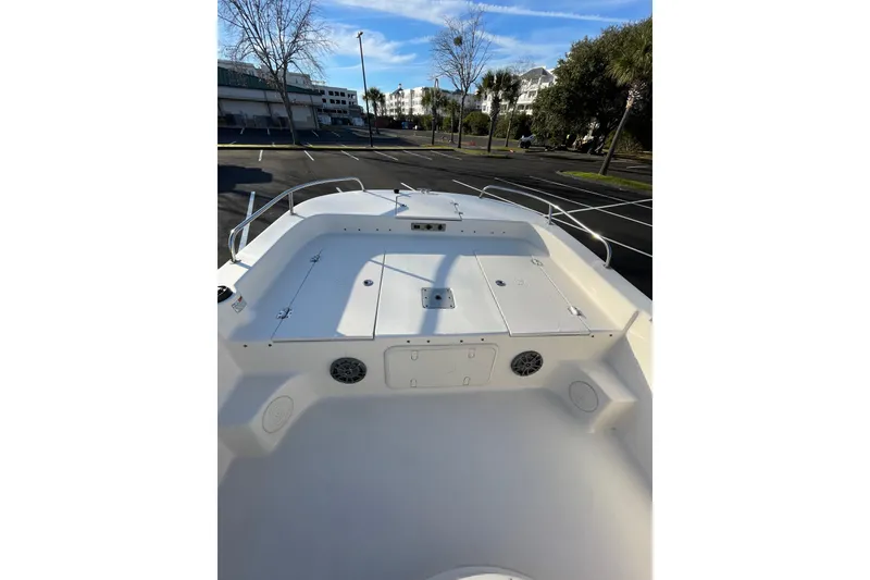 Slide: The Image of 2023 Carolina Skiff 21 LS boat deck with storage compartments and railing. - 5
