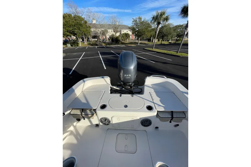 Slide: The Image of 2023 Carolina Skiff 21 LS boat with outboard motor in parking lot. - 6