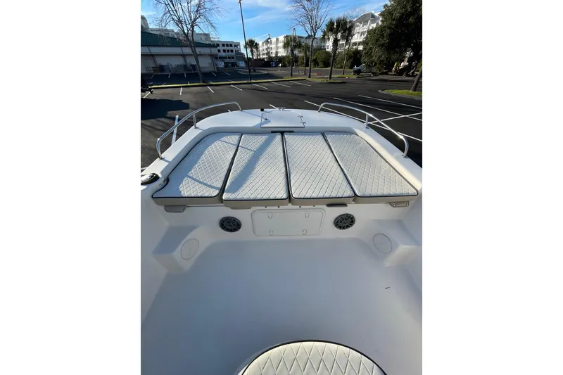 Slide: The Image of 2023 Carolina Skiff 21 LS boat interior with cushioned seating and storage compartments. - 9