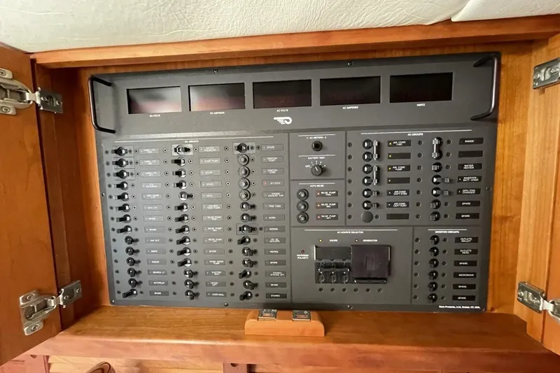 Slide: The Image of Control panel of a 2012 Hinckley Runabout 38, featuring various switches and indicators. - 8