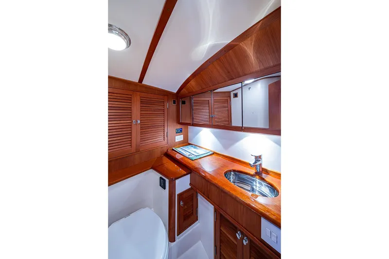 Slide: The Image of Luxurious wooden interior of 2012 Hinckley Runabout 38 yacht bathroom. - 13