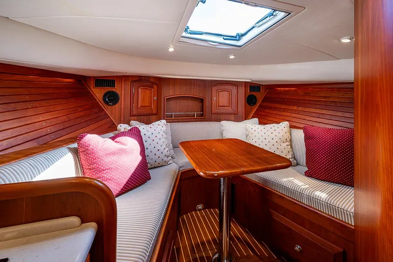 Slide: The Image of Luxurious interior of 2012 Hinckley Runabout 38 with wood finish and cozy seating. - 9