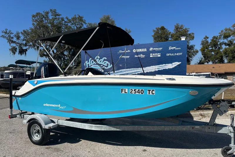 The Image of 2022 Bayliner Element M17 boat on trailer, blue hull, outdoor display. - 0