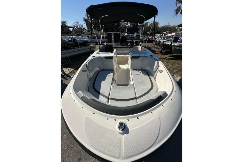 Slide: The Image of 2022 Bayliner Element M17 boat with spacious seating and canopy, docked outdoors. - 13