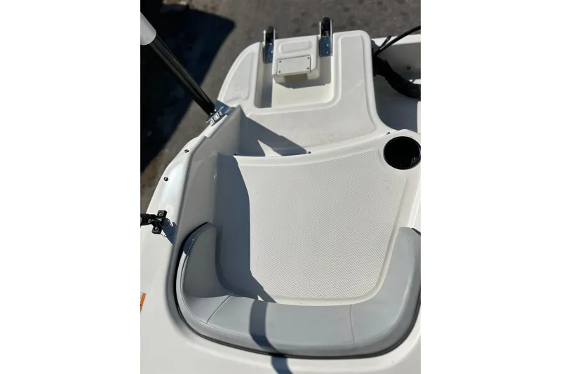 Slide: The Image of 2022 Bayliner Element M17 boat interior with seating and cup holder. - 16
