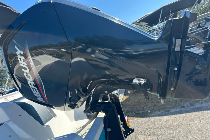 Slide: The Image of 2022 Bayliner Element M17 with Mercury outboard engine, parked outdoors. - 18