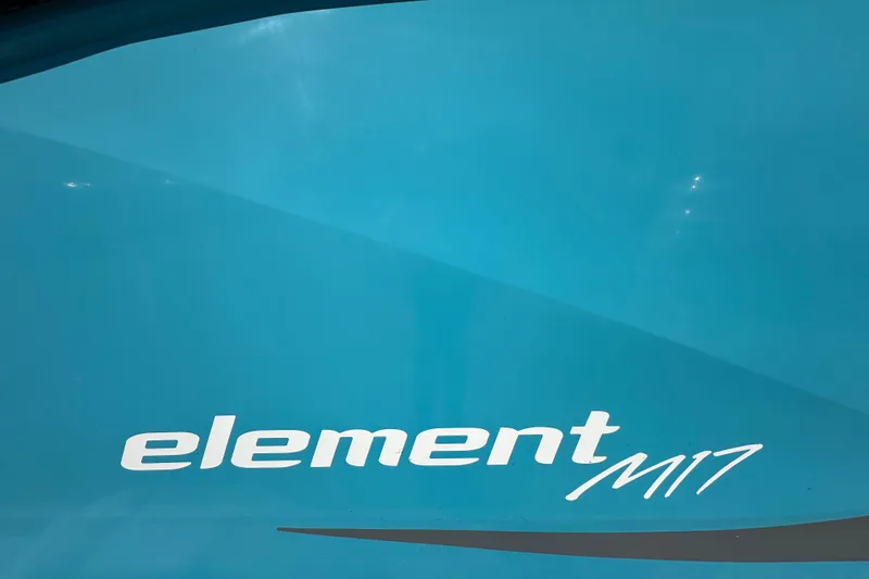Slide: The Image of 2022 Bayliner Element M17 boat logo on a blue surface. - 2