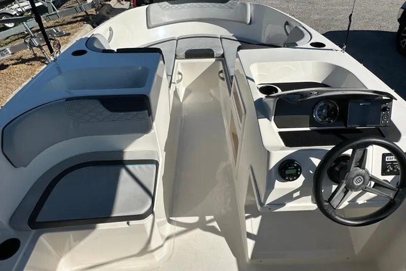 Slide: The Image of 2022 Bayliner Element M17 boat interior with steering wheel and seating area. - 3