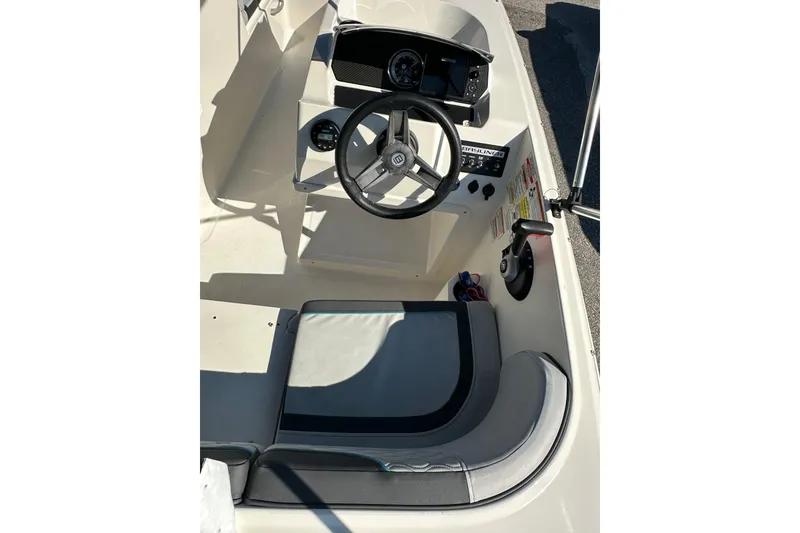 Slide: The Image of 2022 Bayliner Element M17 boat cockpit with steering wheel and controls. - 4