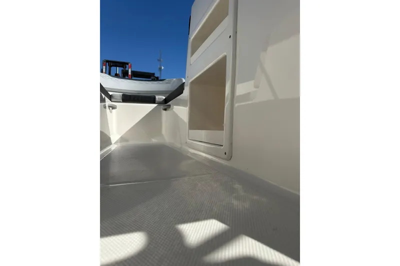 Slide: The Image of 2022 Bayliner Element M17 boat interior with storage compartment, under clear blue sky. - 7
