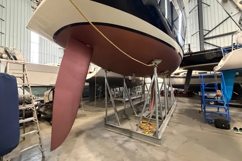 Slide: The Image of 2006 Beneteau First 36.7 sailboat in dry dock, showcasing keel and hull. - 10