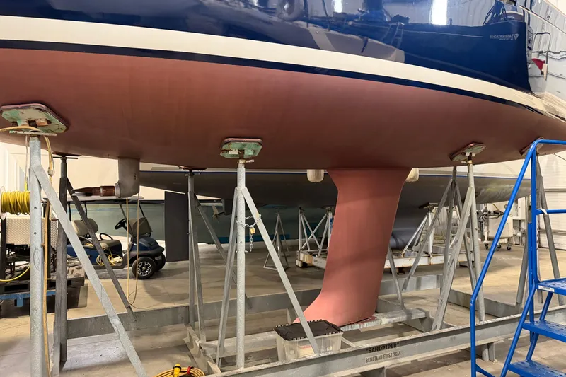 Slide: The Image of 2006 Beneteau First 36.7 sailboat in dry dock, showcasing hull and keel. - 12