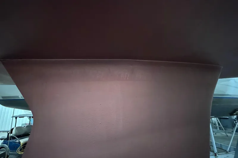 Slide: The Image of Close-up of the keel of a 2006 Beneteau First 36.7 sailboat in a workshop. - 15