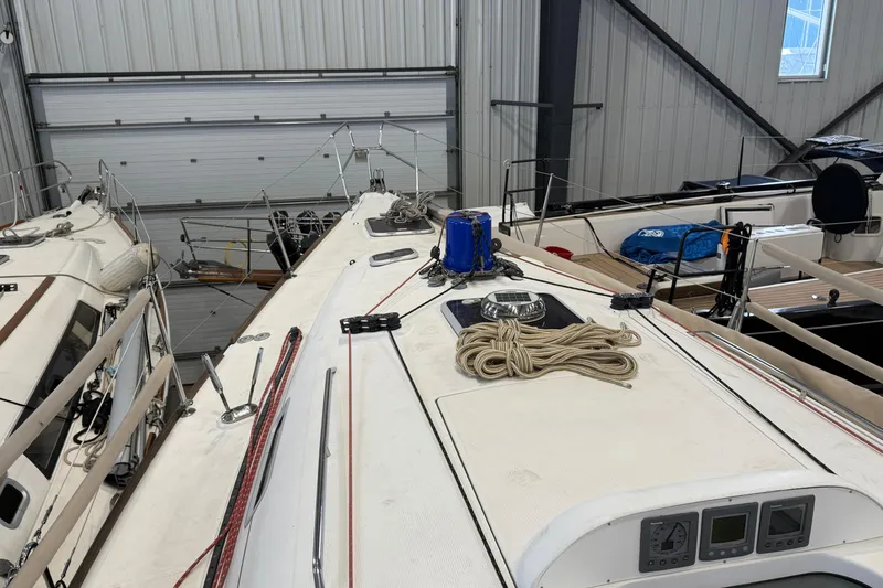 Slide: The Image of 2006 Beneteau First 36.7 sailboat in indoor storage, showcasing deck and rigging. - 19