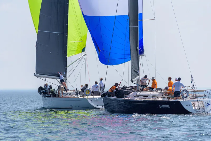 Slide: The Image of Sailboats racing on open water, featuring a 2006 Beneteau First 36.7 model. - 2