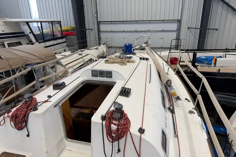 Slide: The Image of 2006 Beneteau First 36.7 sailboat in storage, showcasing deck and rigging details. - 21