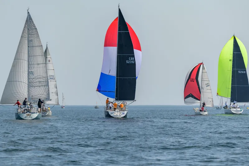 Slide: The Image of Sailboats racing on open water, featuring a 2006 Beneteau First 36.7 model. - 3