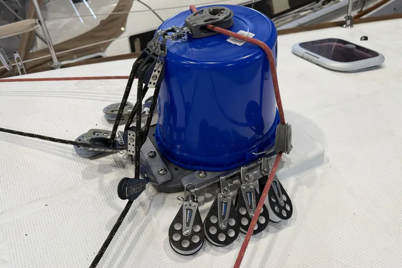 Slide: The Image of Blue bucket on Beneteau First 36.7 sailboat deck, 2006 model, with rigging and pulleys. - 37