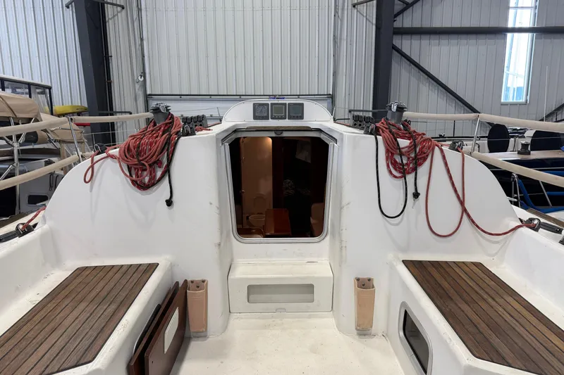 Slide: The Image of 2006 Beneteau First 36.7 sailboat cockpit with ropes and wooden seating in a marina. - 41