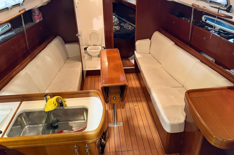 Slide: The Image of Interior of 2006 Beneteau First 36.7 yacht with wooden flooring and white seating. - 43