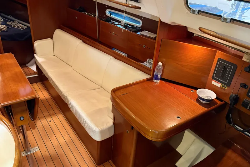 Slide: The Image of Interior of 2006 Beneteau First 36.7 yacht with wooden finish and white seating. - 45