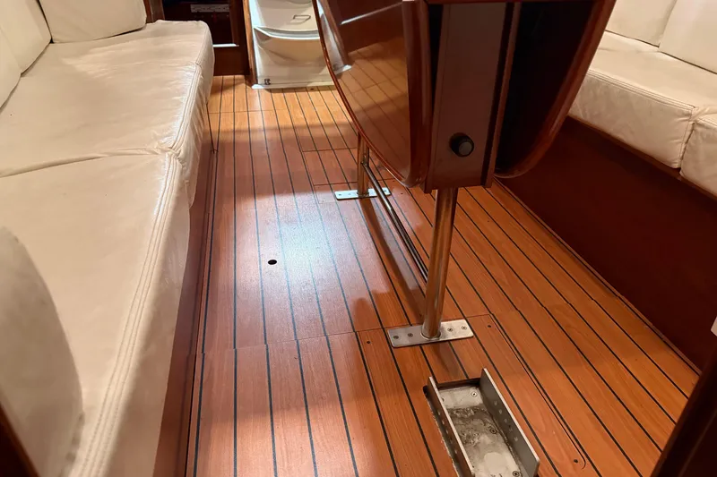 Slide: The Image of Interior of 2006 Beneteau First 36.7 yacht with wooden flooring and cushioned seating. - 46