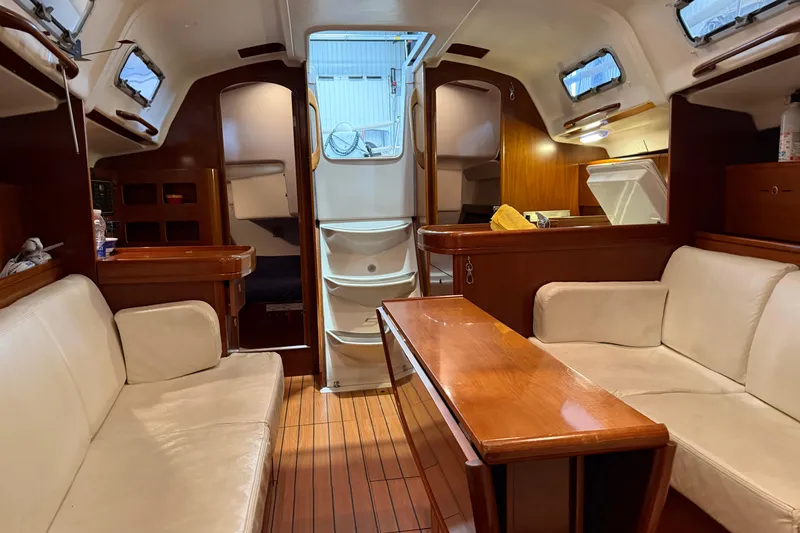 Slide: The Image of Interior of 2006 Beneteau First 36.7 sailboat with cozy seating and wooden finishes. - 52