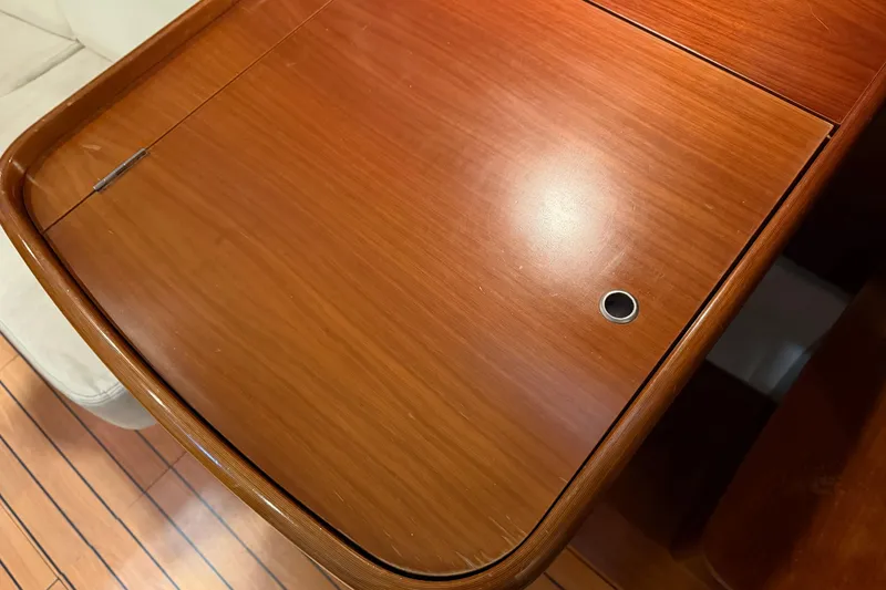 Slide: The Image of Wooden table surface on a 2006 Beneteau First 36.7 yacht interior. - 53