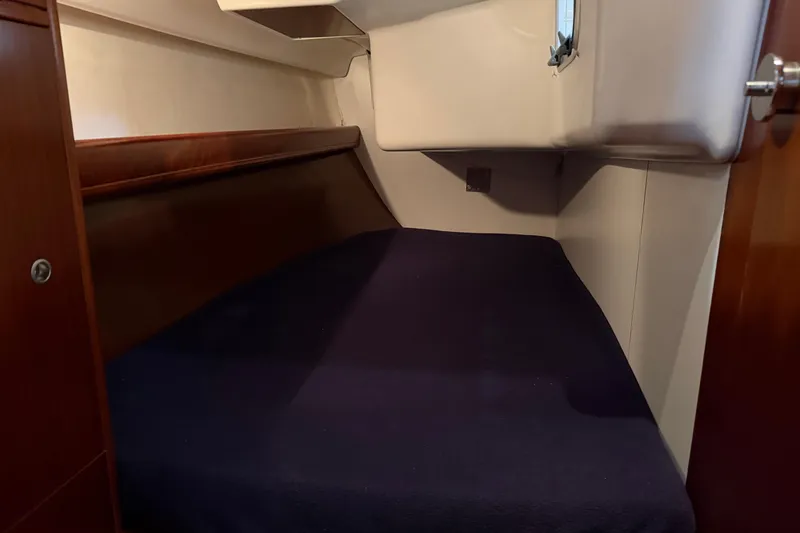 Slide: The Image of Cozy cabin interior of 2006 Beneteau First 36.7 sailboat with dark bedding. - 56