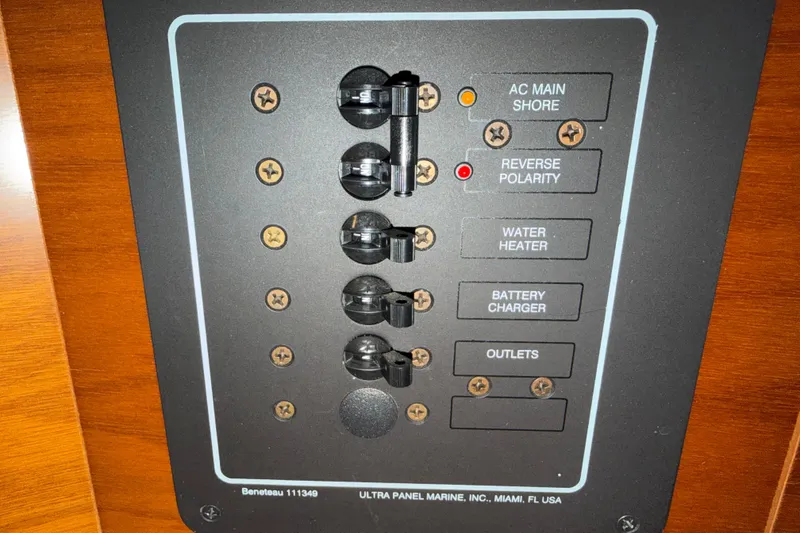 Slide: The Image of Electrical panel of a 2006 Beneteau First 36.7 sailboat with labeled switches. - 59