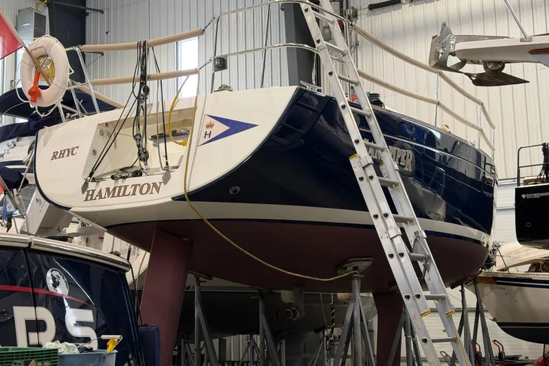 Slide: The Image of 2006 Beneteau First 36.7 sailboat in a marina, elevated on supports. - 6