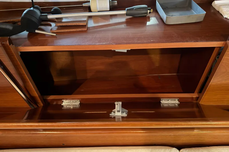 Slide: The Image of Open wooden cabinet inside a 2006 Beneteau First 36.7 sailboat interior. - 67