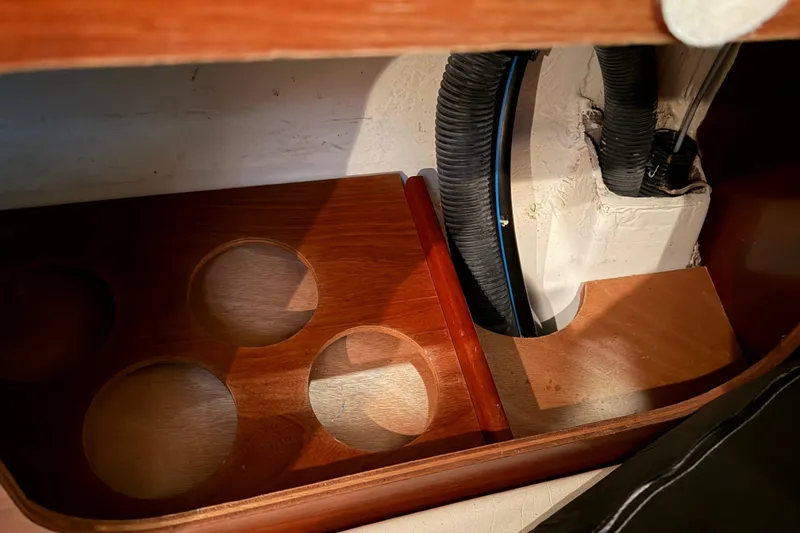 Slide: The Image of Interior detail of a 2006 Beneteau First 36.7 sailboat, featuring wooden storage compartments. - 69