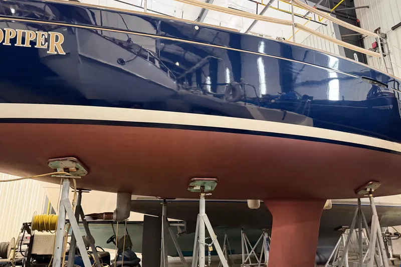 Slide: The Image of 2006 Beneteau First 36.7 sailboat in dry dock, showcasing hull and keel. - 7