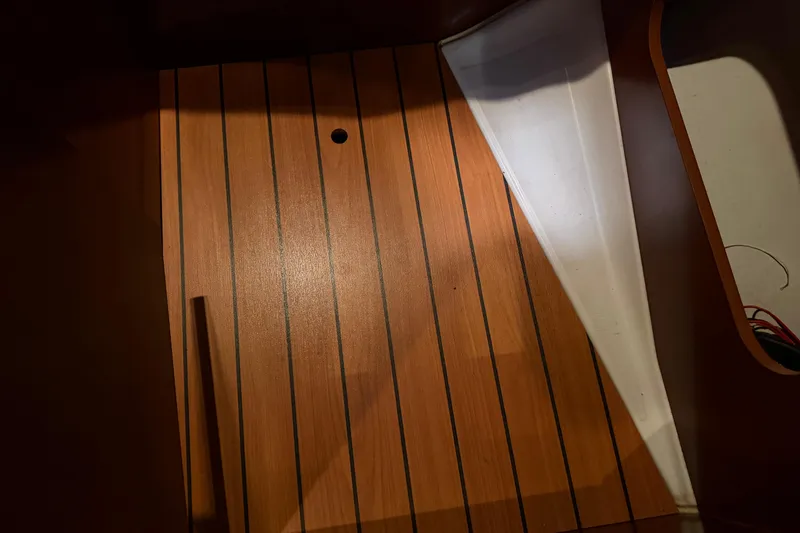 Slide: The Image of Wooden interior flooring of a 2006 Beneteau First 36.7 sailboat. - 73
