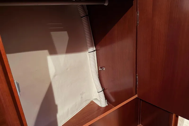 Slide: The Image of Interior view of a 2006 Beneteau First 36.7 sailboat cabinet with visible piping. - 74