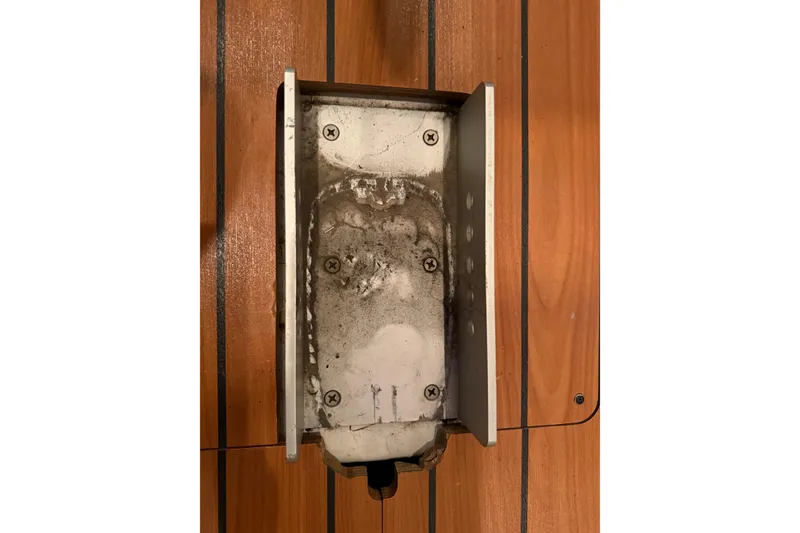 Slide: The Image of Worn metal bracket on Beneteau First 36.7 yacht, 2006 model, mounted on wooden surface. - 75