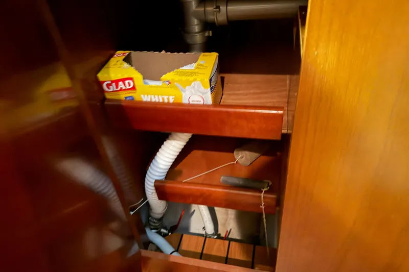 Slide: The Image of Interior storage of 2006 Beneteau First 36.7 sailboat with plumbing and Glad wrap. - 78