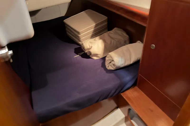 Slide: The Image of Cozy cabin interior of 2006 Beneteau First 36.7 sailboat with bedding and storage. - 83