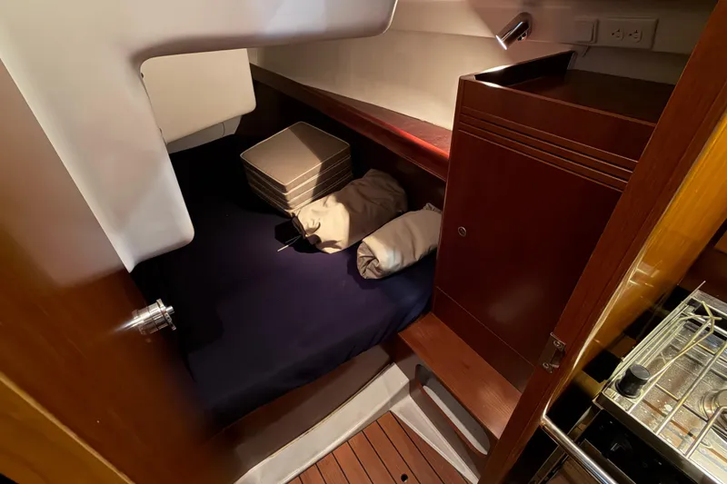 Slide: The Image of Cozy cabin interior of 2006 Beneteau First 36.7 sailboat with bedding and storage. - 84