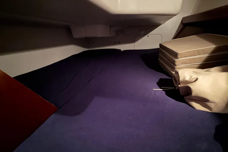 Slide: The Image of Interior cabin of 2006 Beneteau First 36.7 sailboat with blue carpet and cushions. - 85